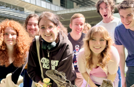 students posing with lizards